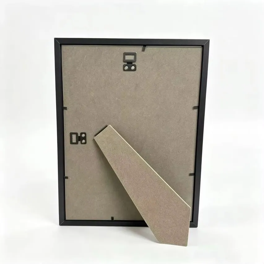 The back of the frame, showing two sawtooth hanging hooks and a fold-out kickstand on a grey backing board.